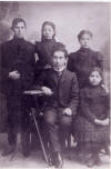 Morris- Florence- Ida- with Nathan Gurevich (Horwitz) sitting. This photo was taken in Europe.